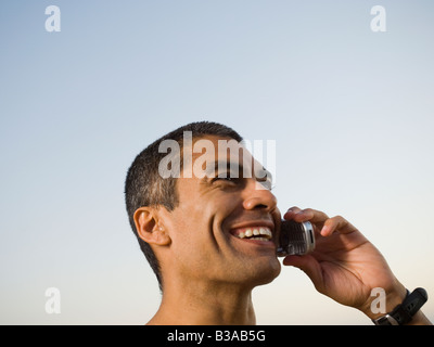 Hispanic man talking on cell phone Stock Photo