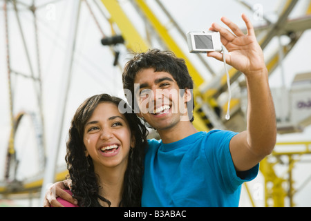 Multi-ethnic teenaged couple taking own photograph Stock Photo
