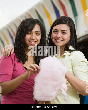 Multi-ethnic teenaged girls eating cotton candy Stock Photo