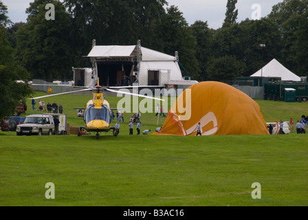 A Balloon being inflated at the Northampton Balloon Festival alongside the Air Ambulance Helicopter Stock Photo