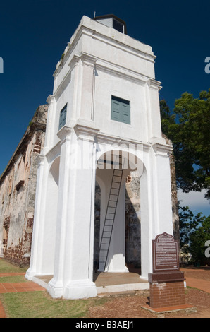 White lighthouse and ruins of the Portuguese built church, originally called Our Lady of The Hill built in 1521, Bukit St Paul, Malacca, Malaysia Stock Photo