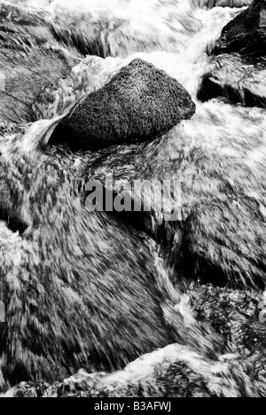 Close up of blurred water rushing between rocks at ButterMilk Falls Stock Photo