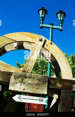rural gold gulch mining sign with a old water wheel and lanterns in rural lifestile area landmark in a cowboy town fun travel Stock Photo