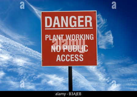 danger plant working no public access sign against blue sky Stock Photo