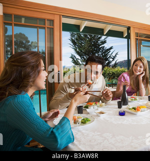 Multi-ethnic couples eating sushi Stock Photo