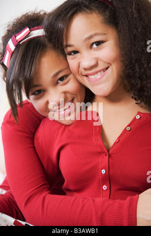 African twin sisters hugging Stock Photo - Alamy