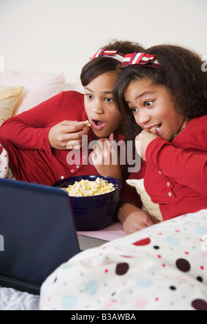 African twin sisters watching movie