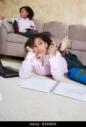 African twin sisters doing homework Stock Photo