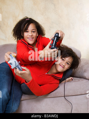 African twin sisters playing video games Stock Photo