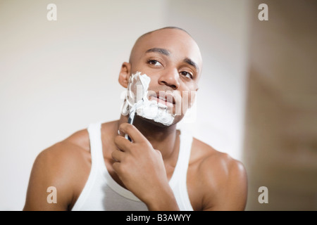 African man shaving face Stock Photo