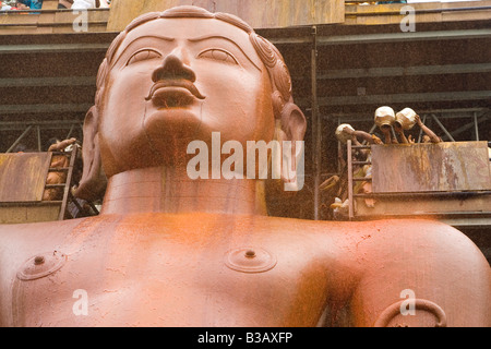 Pilgrims anoint the statue of Lord Bahubali during the Mahamastakabisheka festival in Shravanabelagola, Karnataka, India. Stock Photo