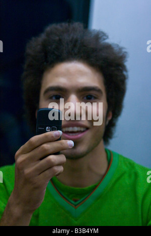 Young Iranian Man Using a Digial Camera Mobile Phone in Tehran Iran Stock Photo