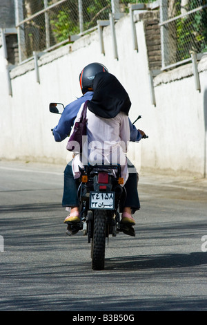 Woman Riding on Back of a Motorcycle in Tehran Iran Stock Photo