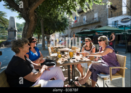 Four Women sitting at a cafe in the Place de la Liberation (more commonly known as the Place Porta), Sartene, Corsica, France Stock Photo
