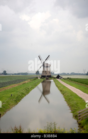 Windmill with river in the foreground shot in Amsterdam, Netherlands. Stock Photo
