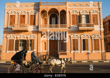 Horse-Drawn Carriage by Colonial Building, Luxor, Egypt Stock Photo