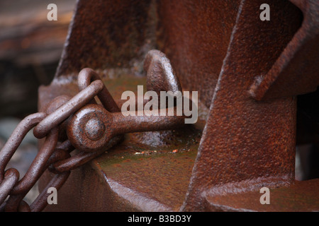 Close up of rusty old shackle lock with open shackle and key next to it ...