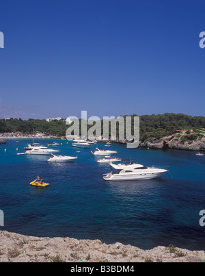 Scene in Cala Mondrago Natural Park - with motor boats and yachts at anchor  - near  Cala D'Or, East Coast Mallorca. Stock Photo