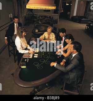 Overhead view of people playing blackjack in casino Stock Photo