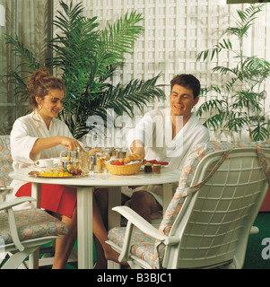 Couple having breakfast on terrace Stock Photo