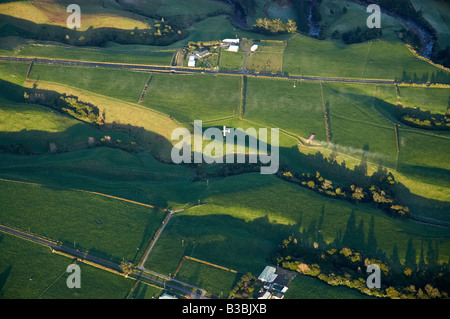 Top Dressing Plane and Early Light on Farmland near Mt Taranaki Mt Egmont Taranaki North Island New Zealand aerial Stock Photo