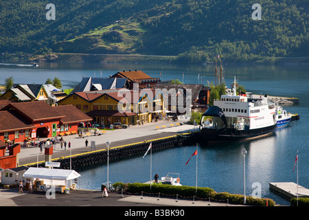 Waterfront ferry dock and shopping area in the Tourist Town of Flam Norway with ferry, tour, and activity boats at the dock Stock Photo