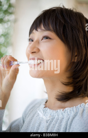 Housewife brushing her teeth Stock Photo