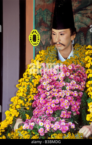 Thousands of chrysanthemum flowers adorn traditional mannequin in an historic theme at the annual Kiku Matsuri in Fukushima Stock Photo