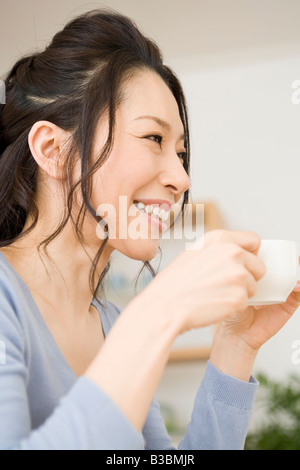 Young woman drinking coffee Stock Photo
