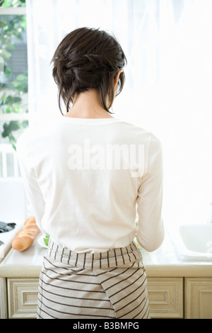 Young woman cooking in kitchen Stock Photo