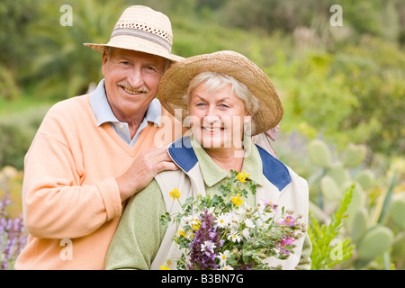 Portrait of Couple, Woman Holding Flowers Stock Photo