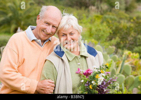 Portrait of Couple, Woman Holding Flowers Stock Photo
