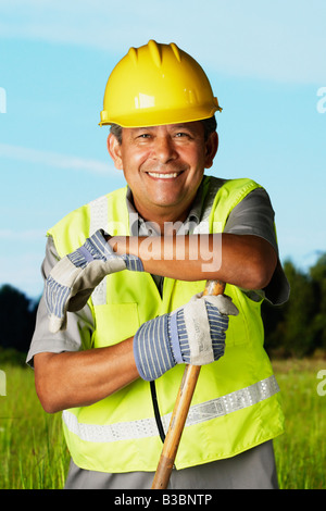 Hispanic man wearing hard hat and reflective vest Stock Photo