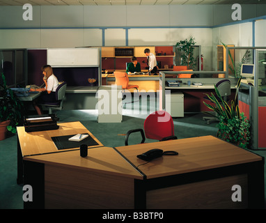 Office interior with empty desk and people working in background Stock Photo