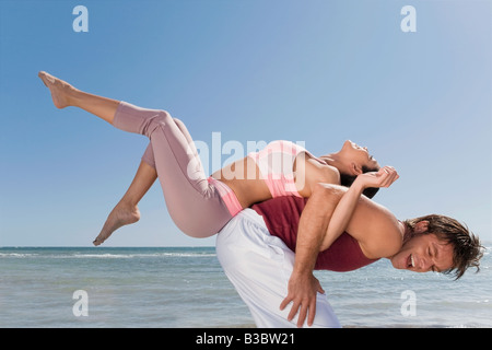 Hispanic man balancing woman on back Stock Photo