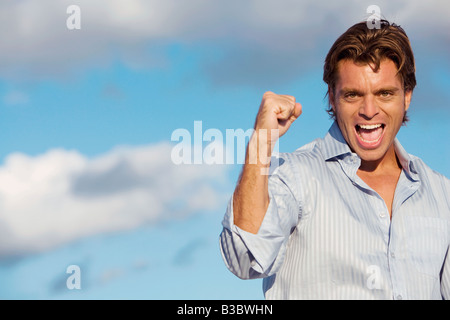 Hispanic man cheering Stock Photo