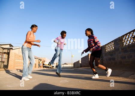 Girls playing on street Stock Photo