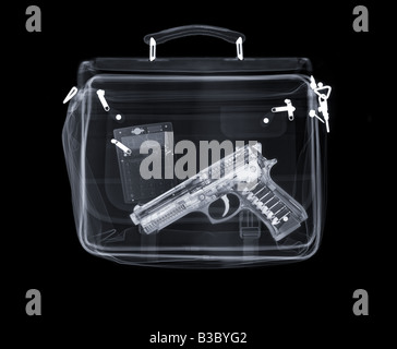 X-ray of a bag containing a gun and a calculator Stock Photo