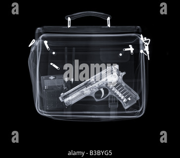 X-ray of a bag containing a gun, pens and a calculator Stock Photo