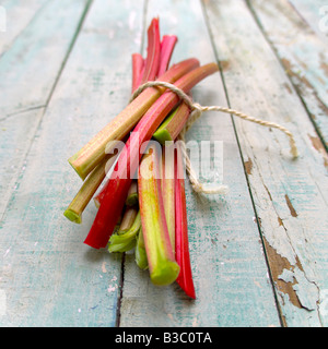 Rhubarb tied in string on a wooden floor Stock Photo
