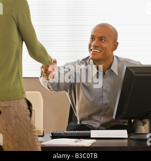 African businessman shaking hands with client Stock Photo