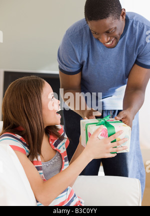 African man giving gift to girlfriend Stock Photo