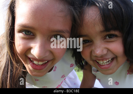 A fun portrait of two mixed race sisters. Stock Photo