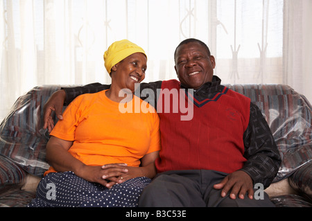 Senior couple sitting on sofa Stock Photo