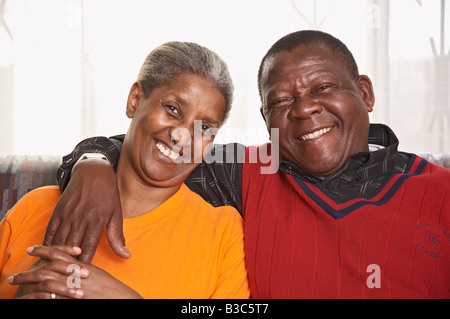Senior couple sitting on sofa Stock Photo