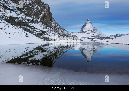 Matterhorn in winter with reflection in the Riffelsee Zermatt Valais Switzerland Stock Photo