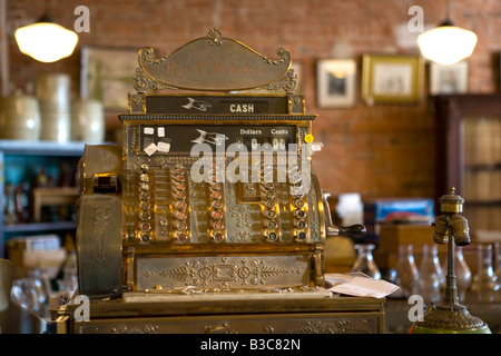 An antique brass cash register in country store Stock Photo