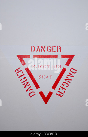 Ejection seat warning sign on the side of a plane Stock Photo - Alamy
