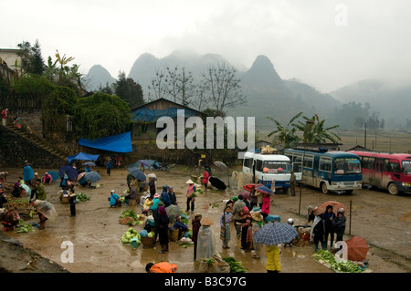The weekend market at Muong Khuong North Vietnam is surrounded by misty mountains Stock Photo