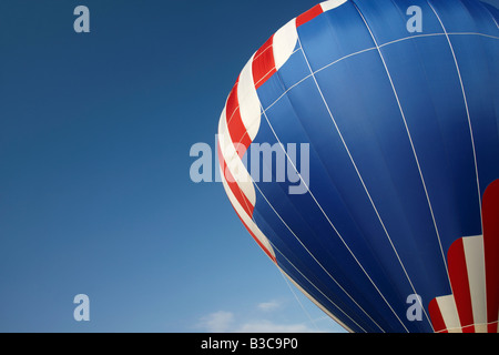 A colorful hot air balloon against a clear blue sky Stock Photo